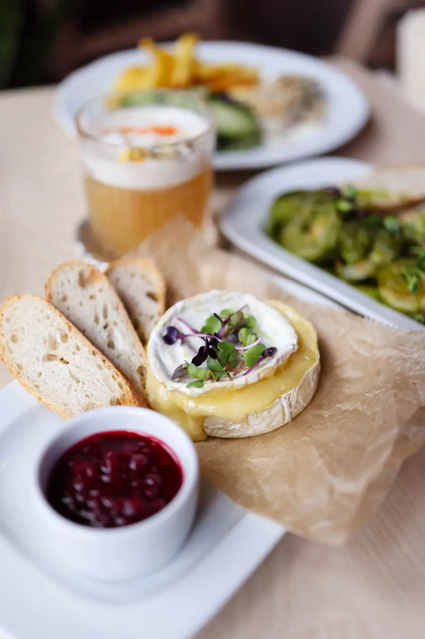 Artisan French cheese with crisp crusty bread and berry preserves
