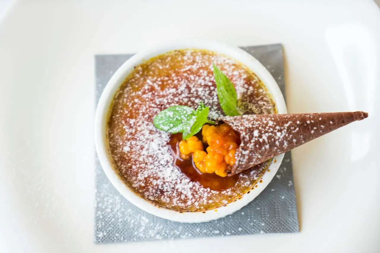 Classic French crème brûlée with caramelised sugar crust and wild berries