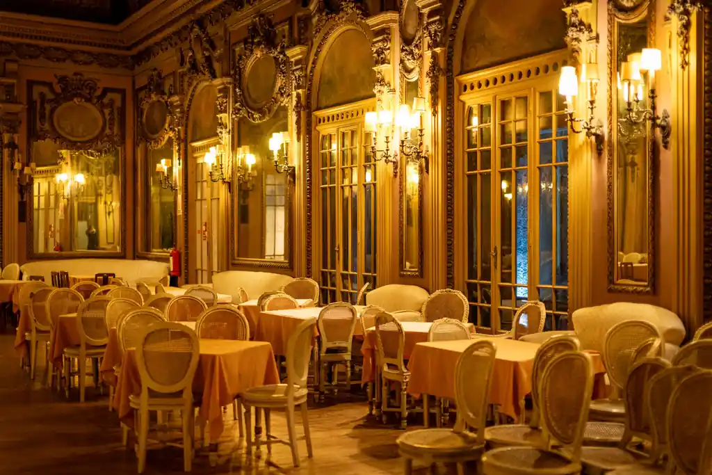 Atmospheric interior dining salon with warm lighting and secluded seating