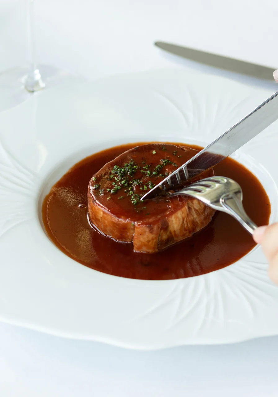 Beef Bourguignon reduction served with glazed shallots and root puree