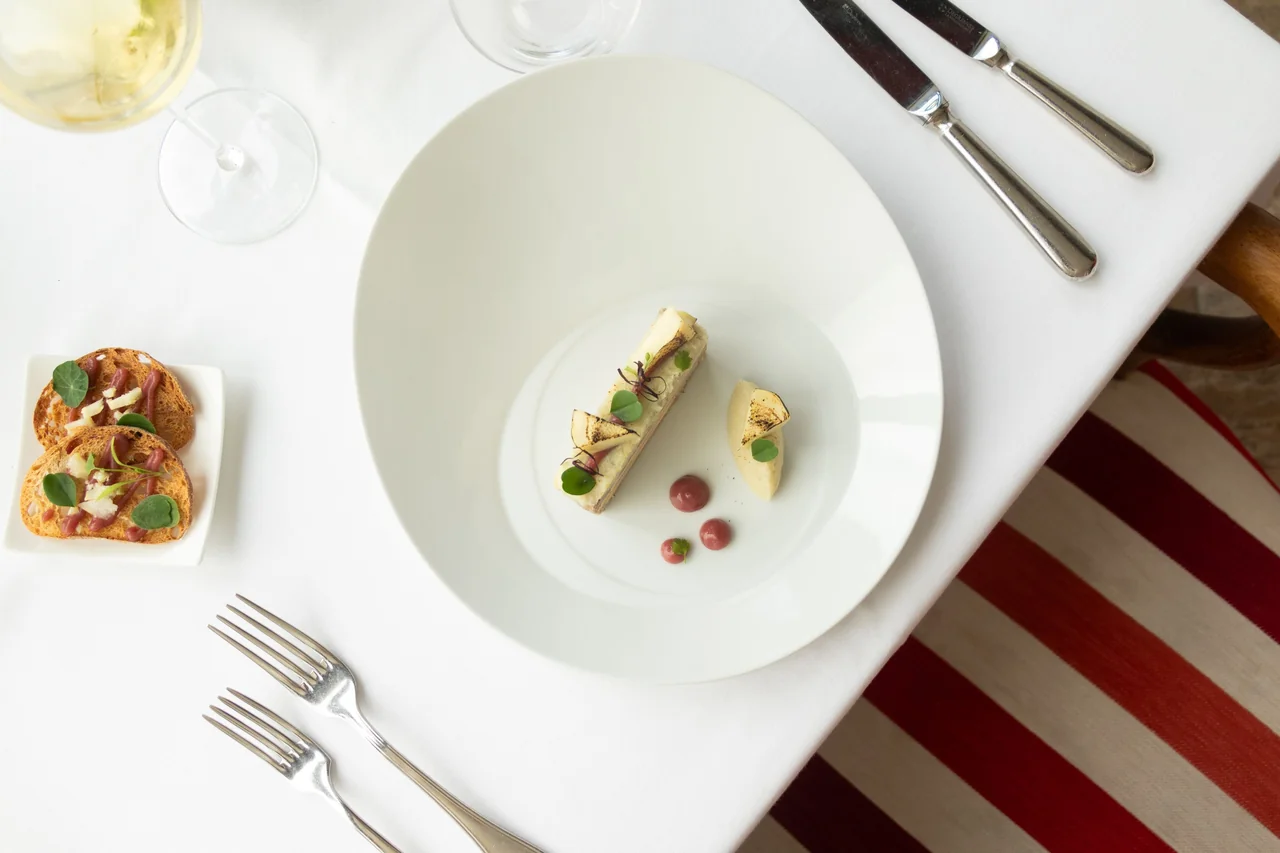 Artisanal French culinary presentation served on refined ceramic tableware