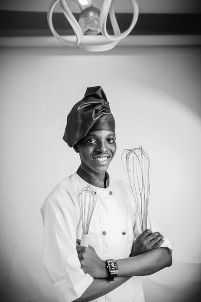 Pastry Chef in chef whites focusing on delicate patisserie work