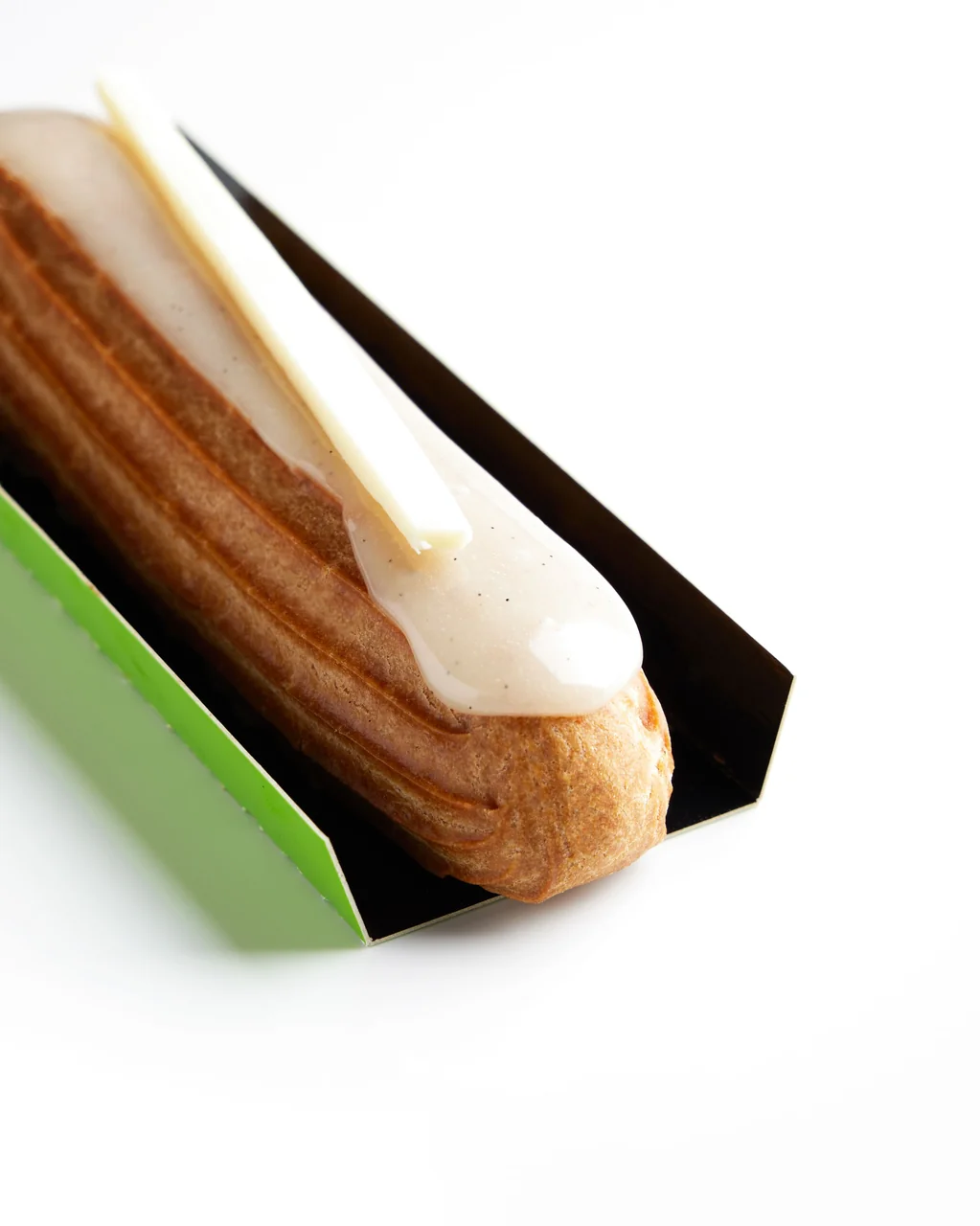 Artisanal French glazed eclair with chocolate craftsmanship
