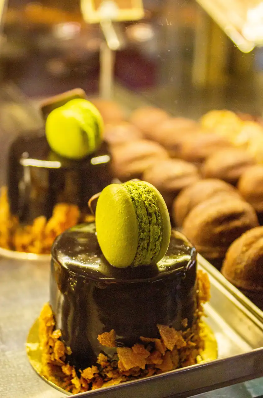 Dark chocolate entremets with pistachio macaron garnish