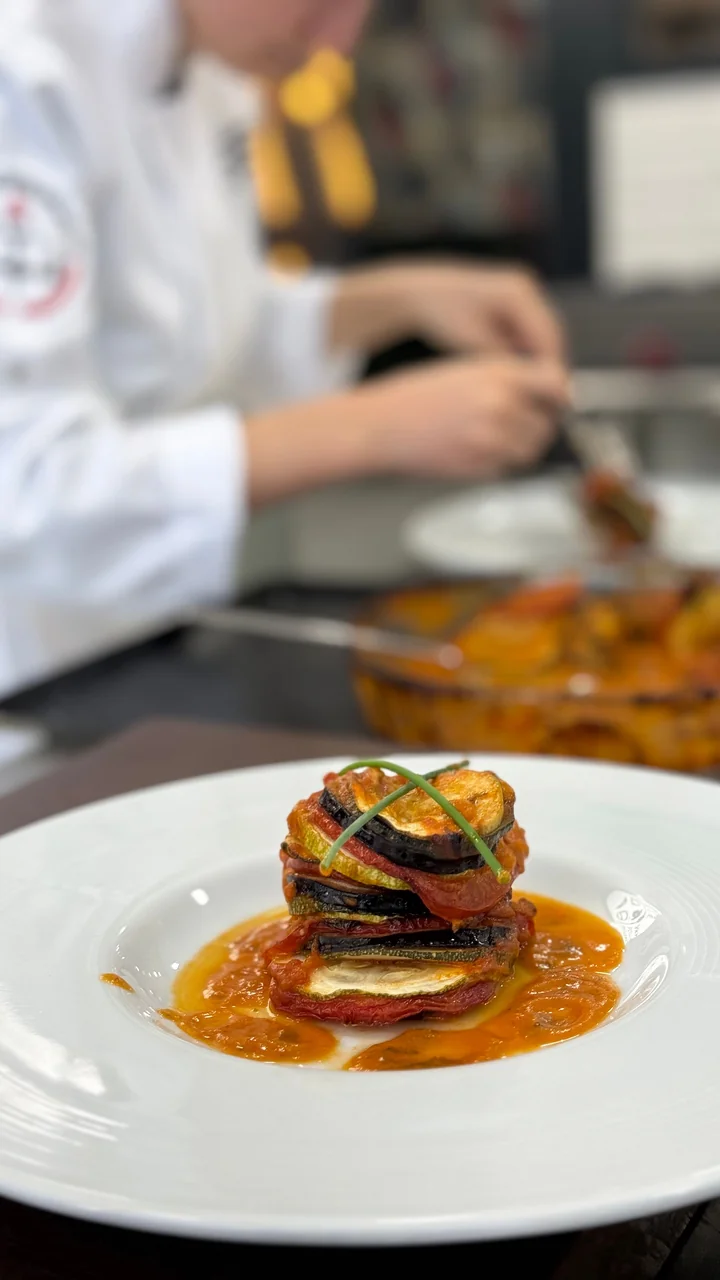 Finely assembled layered vegetable ratatouille in a chef kitchen