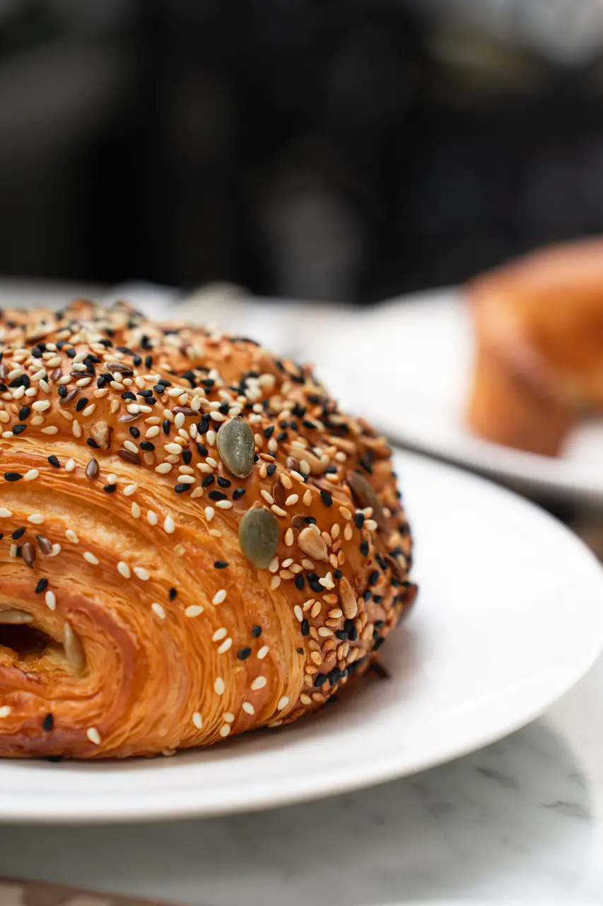 Warm golden croissant served on bespoke tableware