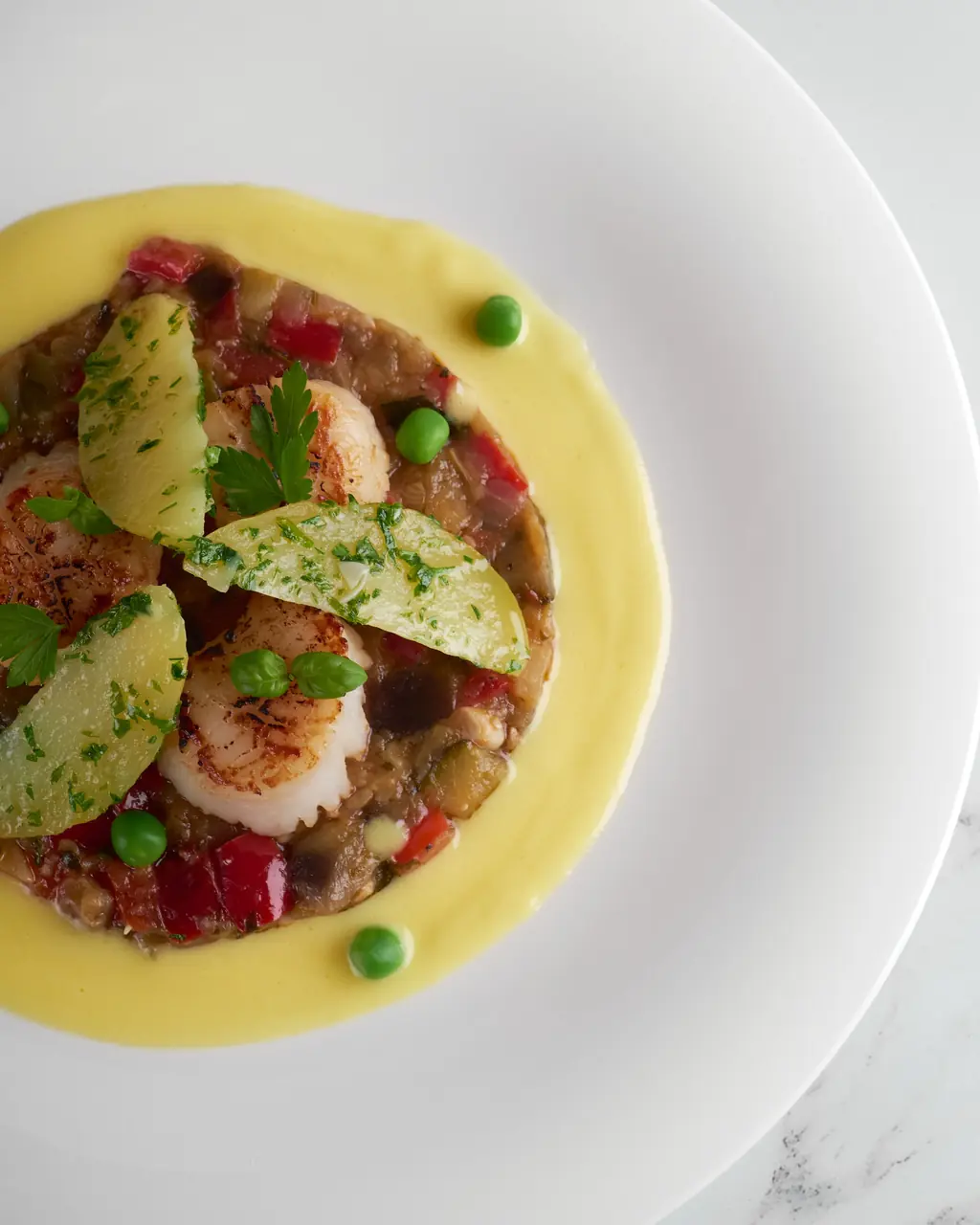 Pan-seared scallop on velvet purée with garden herbs